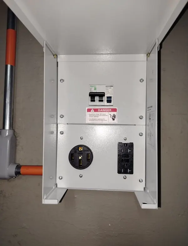 Tablero con protecciones y toma NEMA 14-50 para cargador de vehículo eléctrico